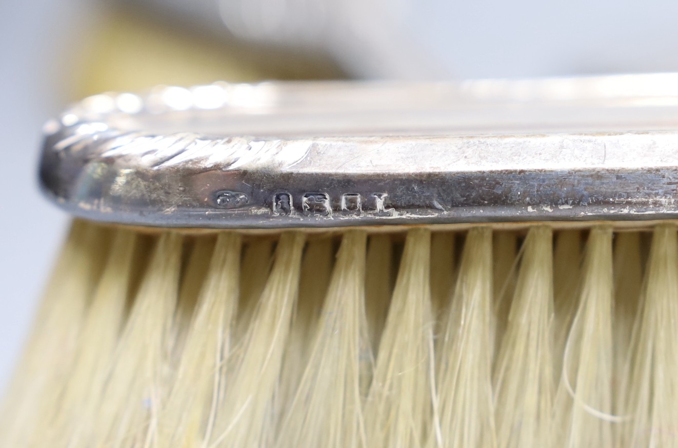 A George V silver and yellow metal five piece dressing table mirror and brush set, by Charles & Richard Comyns, London, 1924.